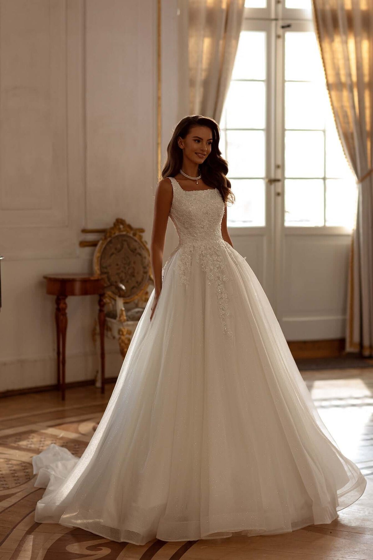 Carson Aline tulle lace wedding dress featuring a square neckline and a flowing silhouette.