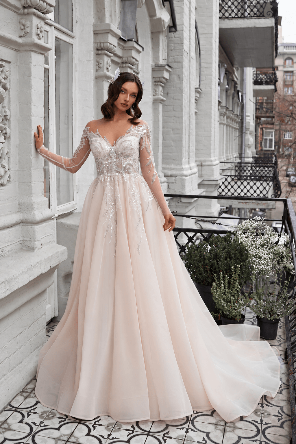 Giselle - Aline Wedding Dress with Long sleeves on a model in an elegant outdoor setting.