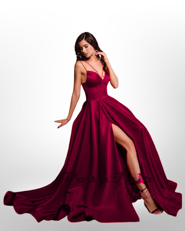 burgundy Aline satin prom dress with thin straps, slit, and pockets.