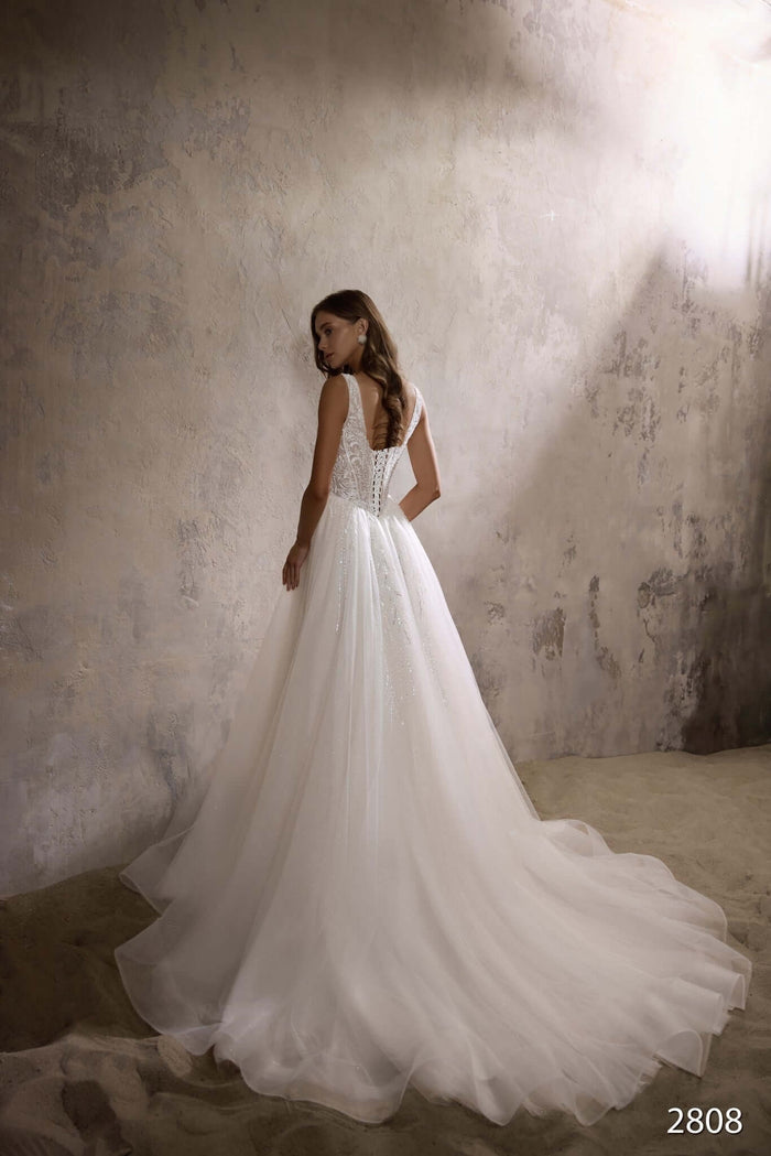 Alida Aline wedding dress with beaded bodice and basque waist, showcasing a beautiful back view.