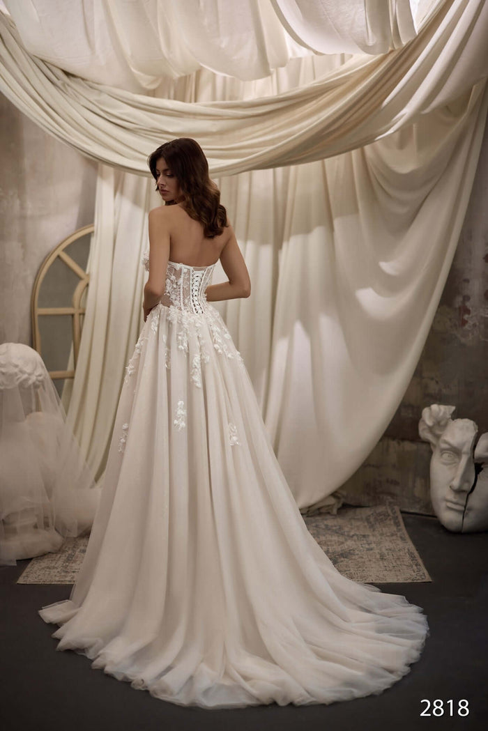 Aline wedding dress featuring a beautiful back with corset detailing and flowy skirt, capturing elegance and grace.