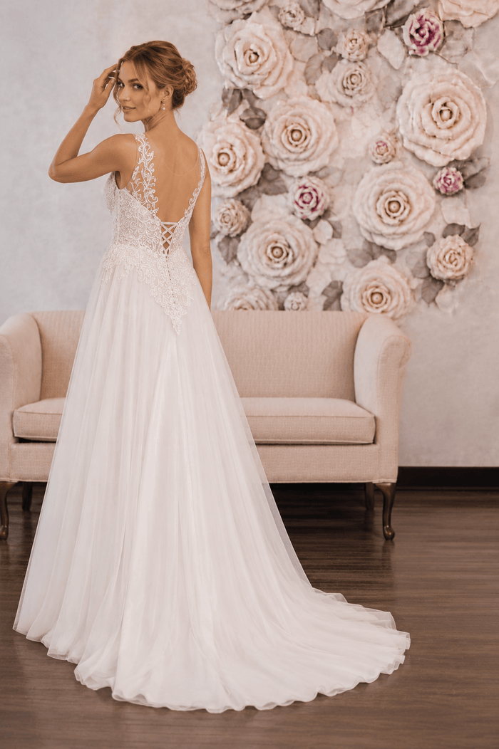 Astra - Aline Tulle Lace Wedding Dress - Size 8 showcased on model in off-white tulle dress with lace details.