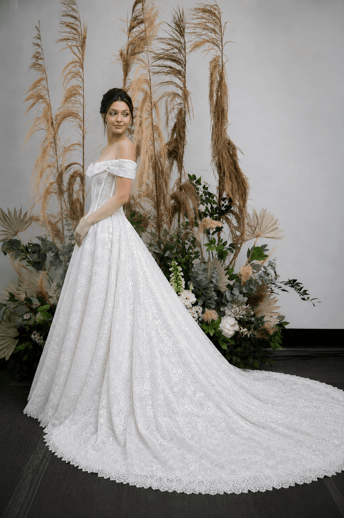 Chantilly lace, ball gown, draped cowl neck, off-shoulder straps, corset bodice, structured waist, floral lace, full skirt, scalloped hem, long train