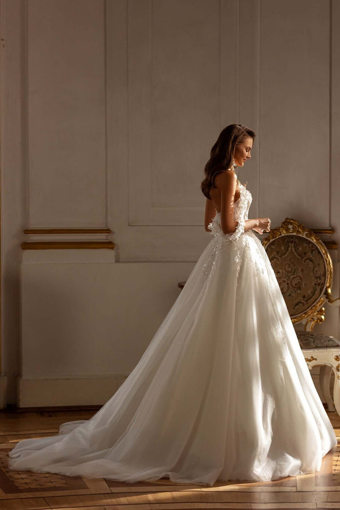 Elegant bride wearing a Becca Aline tulle lace wedding dress with off the shoulder straps and 3D lace details.