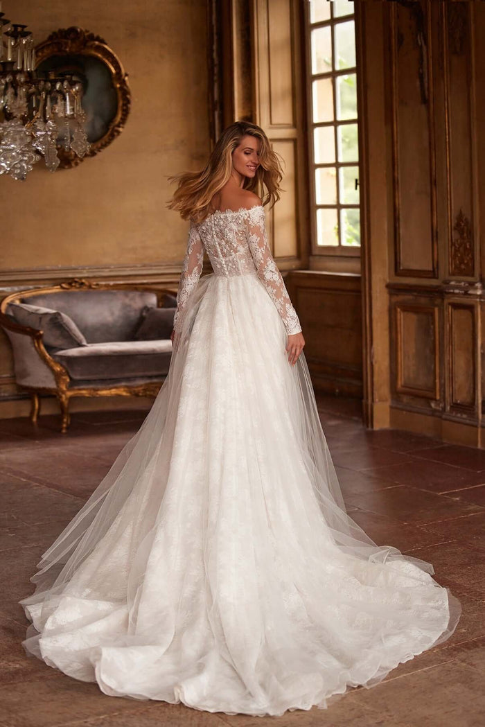 Grace lace wedding gown with Chantilly lace detailing and a flowing skirt, showcasing an elegant bridal look.