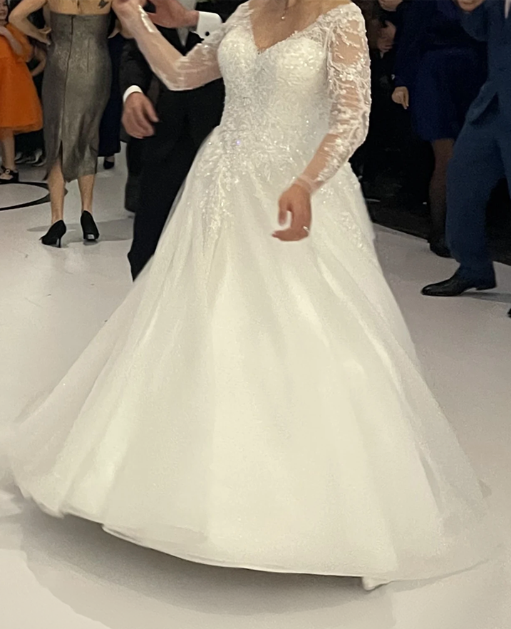 Bride wearing a custom long-sleeve lace ball gown wedding dress