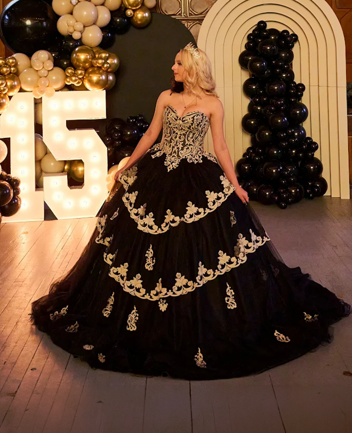 Custom black and gold quinceañera dress with embroidered details and full ball gown skirt