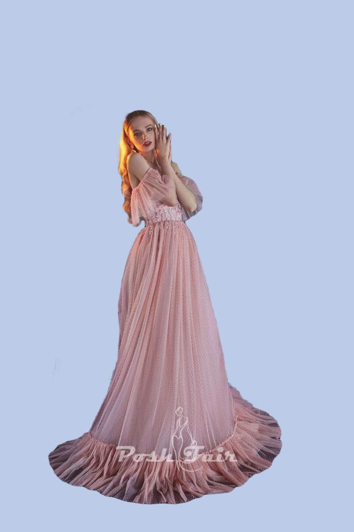 Elegant model in pink tulle evening dress with sweetheart neckline and ruched skirt.